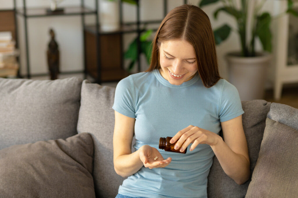 Woman taking vitamin pills.